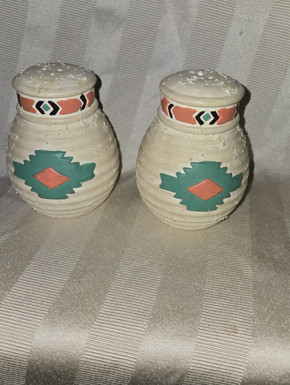 Handcrafted Southwestern Salt and Pepper Shakers with Teal and Coral Accents.